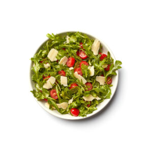 Fresh arugula and strawberry salad on white plate – restaurant menu photographer Toronto