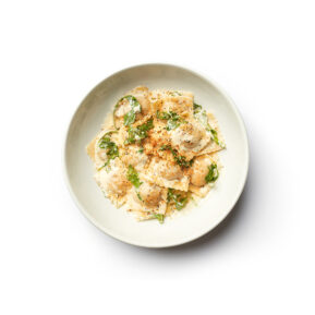 Creamy pasta with mushrooms and herbs on white plate – restaurant food photographer Toronto